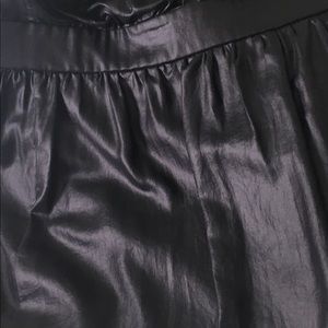 Black top with extendable spaghetti straps.